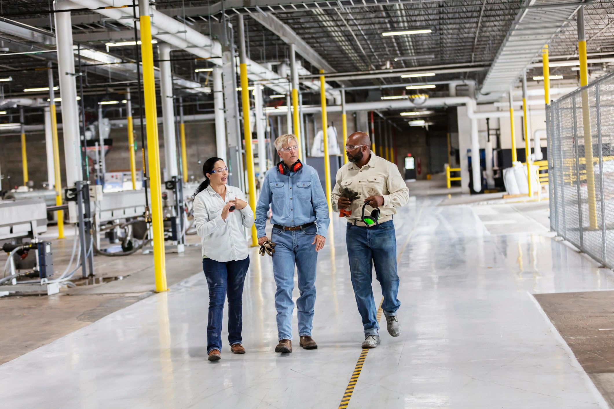 Workforce partners walking through an industrial facility