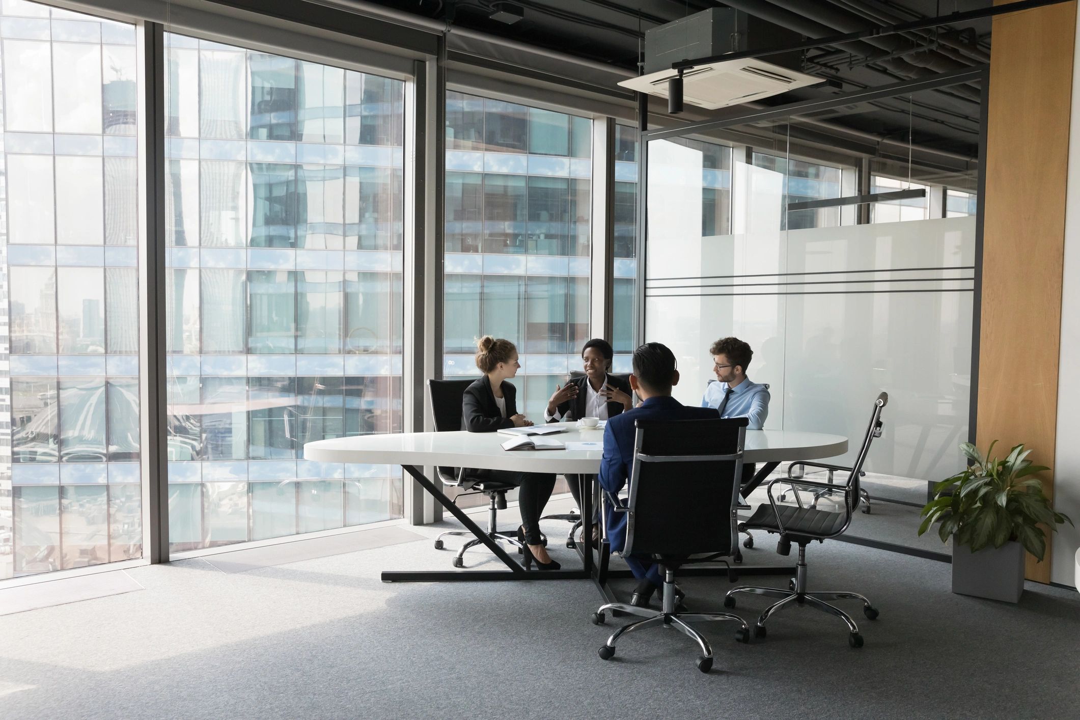 Diverse staffing team meeting in a modern office