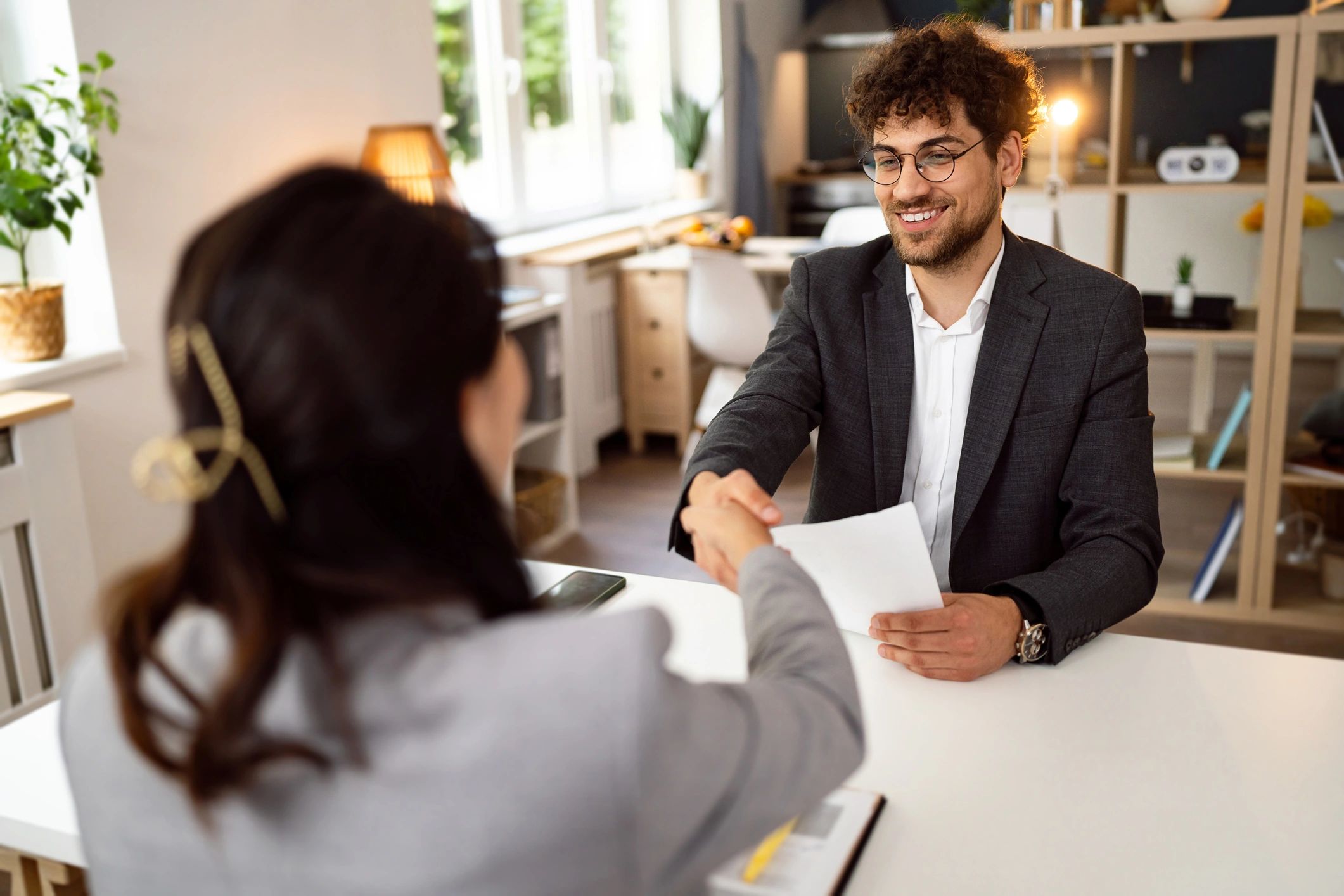 Candidate shaking hands with recruiter after interview